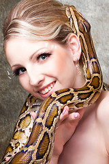 Image showing Attractive nude blond woman with python on grey