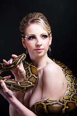 Image showing attractive nude blond woman with python on black