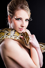 Image showing attractive nude blond woman with python on black