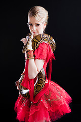 Image showing beautiful ballerina girl in a red scenic dress with  python on black