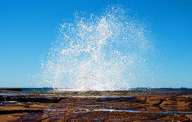 Image showing big splash waves hitting rocks