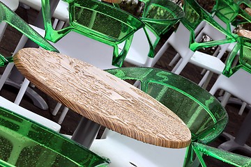 Image showing wet restaurant tables and chairs