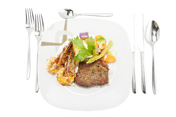Image showing Grilled steak and shrimp served on mashed potatoes with vegetabl