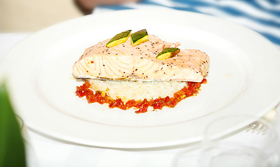 Image showing Plate with baked salmon and rice with vegetables