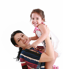 Image showing little girl hugging to mother, in her arms 