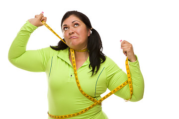 Image showing Frustrated Hispanic Woman Tied Up With Tape Measure
