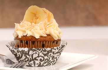 Image showing Delicious carrot cake cupcake with cream cheese frosting, sliced