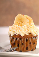 Image showing Delicious carrot cake cupcake with cream cheese frosting, sliced