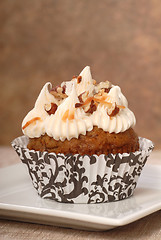 Image showing Delicious carrot cake cupcake with cream cheese frosting and nut