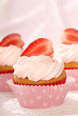 Image showing Vanilla cupcakes with stawberry frosting and strawberries