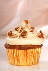 Image showing Delicious carrot cake cupcake with cream cheese frosting and nut