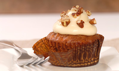 Image showing Delicious carrot cake cupcake with cream cheese frosting and nut