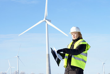 Image showing engineer or architect with white safety hat and wind turbines on