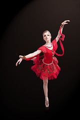 Image showing beautiful ballerina wearing red tutu posing on black 