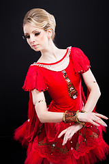 Image showing beautiful ballerina wearing red tutu posing on black 