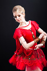 Image showing ballerina wearing red tutu posing on black