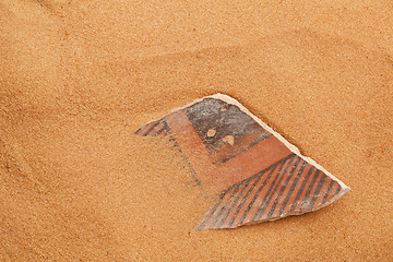 Image showing Anasazi pottery shard in red sand