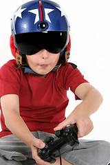 Image showing Child in helmet playing a flight simulator