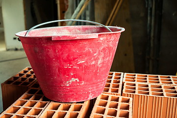 Image showing Bucket on hollow bricks