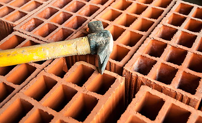 Image showing Hollow brick with hammer