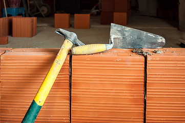 Image showing Hammer and trowel on construction site