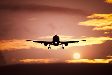 Image showing plane in the sunset sky