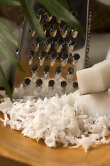 Image showing Grated coconut with grater and nut 