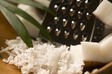 Image showing Grated coconut with grater and nut 