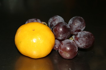 Image showing Red grapes and orange