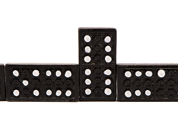 Image showing Sequence of black domino parts isolated on white 