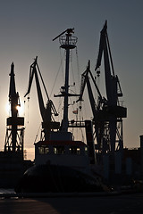 Image showing shipyard cranes and tugboat