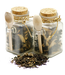 Image showing Tea leaves in transparent parisons with wooden spoon