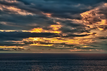 Image showing sunset on an overcast sea 