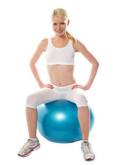 Image showing Gorgeous teenager sitting on exercise ball