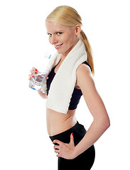 Image showing Fit female athlete holding a bottle of water