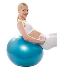 Image showing Beautiful teenage girl back stretch over exercise ball