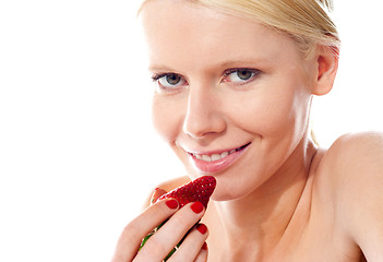 Image showing Closeup of young gorgeous girl holding strawberry