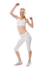 Image showing Cheerful sporty fit girl in sporty outfit