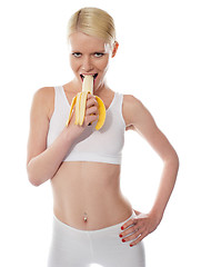 Image showing Starving sexy woman eating banana