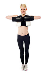 Image showing Happy female boxer posing with gloves on