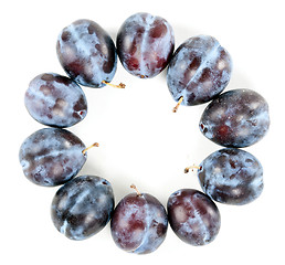 Image showing Ripe plums arranged around