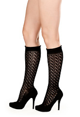 Image showing female legs in fishnet socks and shoes