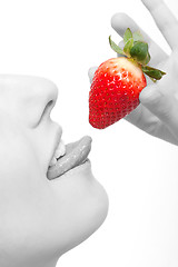 Image showing close-up woman´s lips and a strawberry