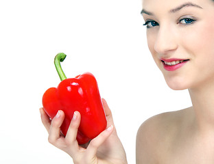 Image showing young beautiful girl with a red pepper in her hand