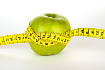 Image showing fresh green apple with yellow measure tape 