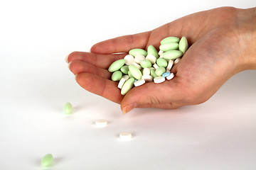 Image showing left hand with pills for healthcare