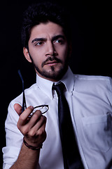 Image showing young successful business man with a suit isolated on black background