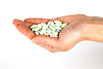 Image showing left hand with pills for healthcare