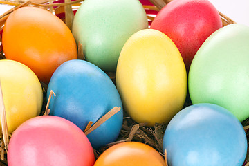 Image showing eastern eggs in different colours in a basket with a rabbit