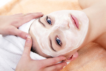 Image showing young beautiful woman with a towel doing wellness